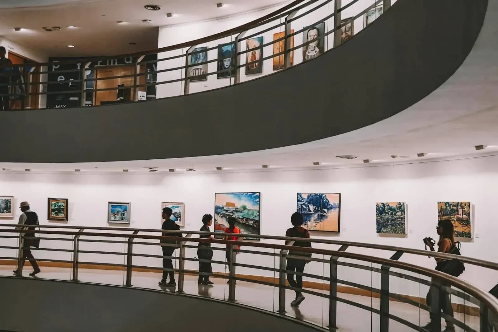 Visitors strolling through a contemporary architecture exhibition hall