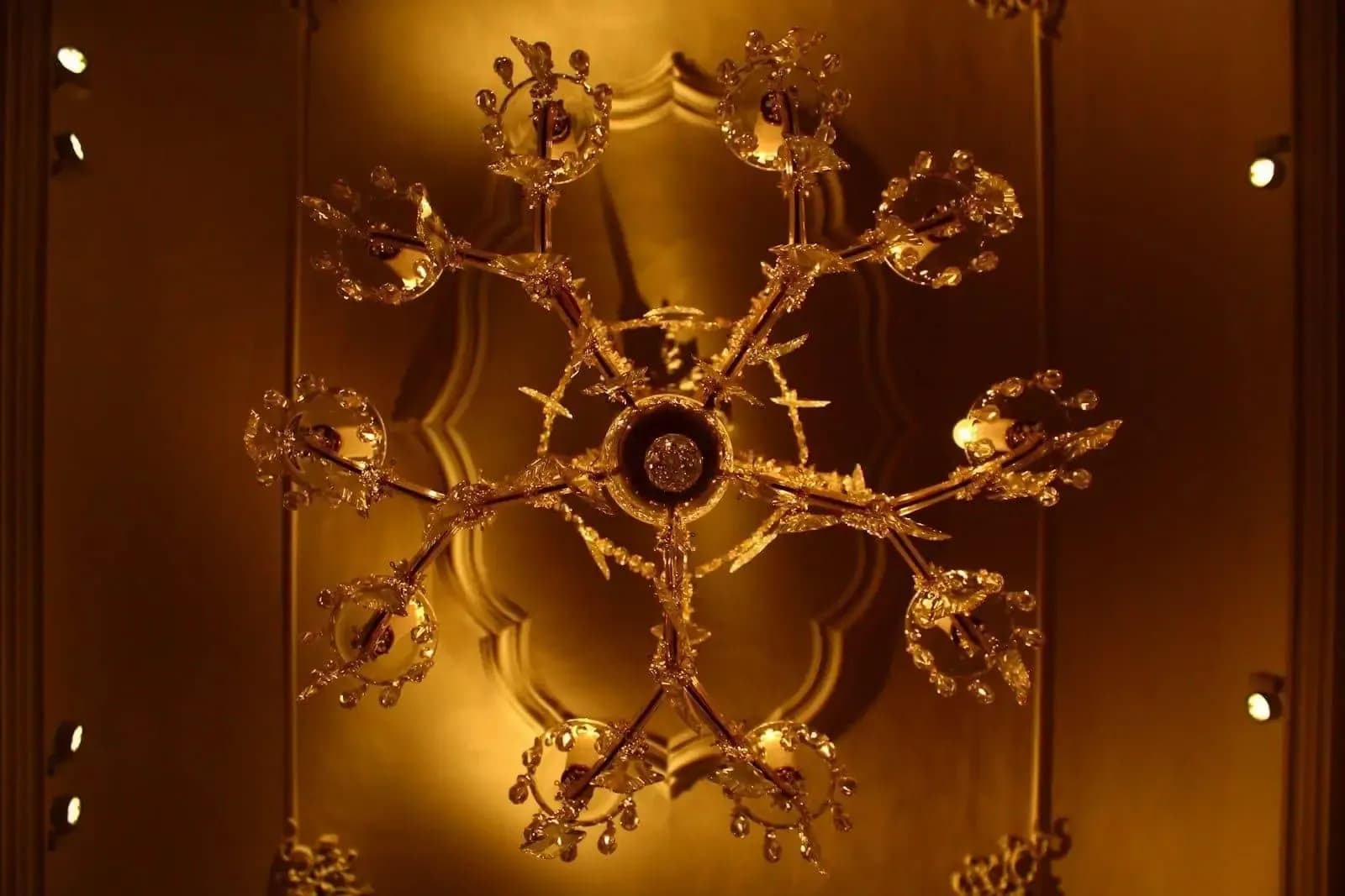 Large crystal chandelier in a historic interior in Prague