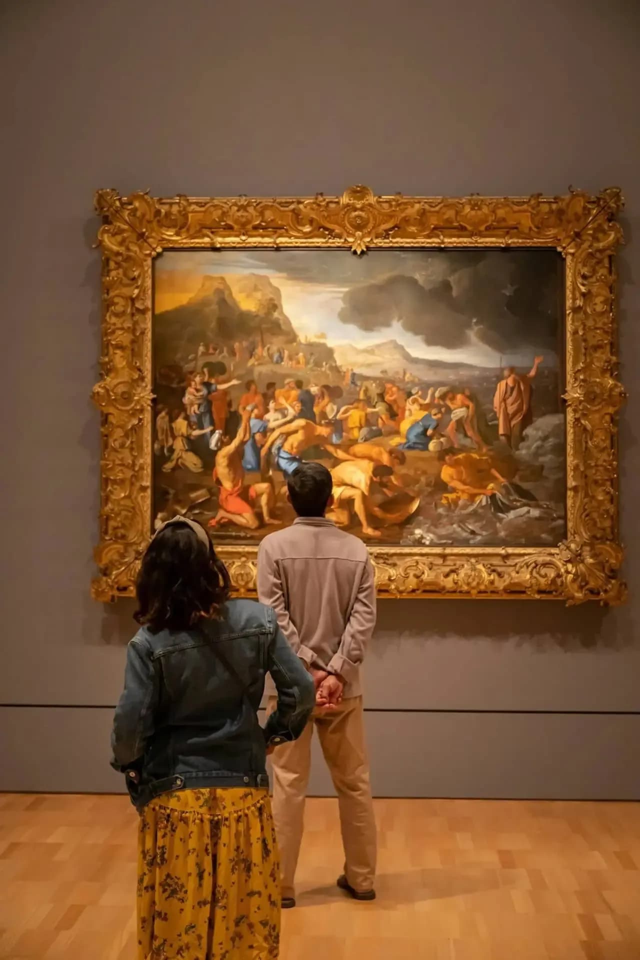 Visitante frente a un cuadro enmarcado en una exposición temporal